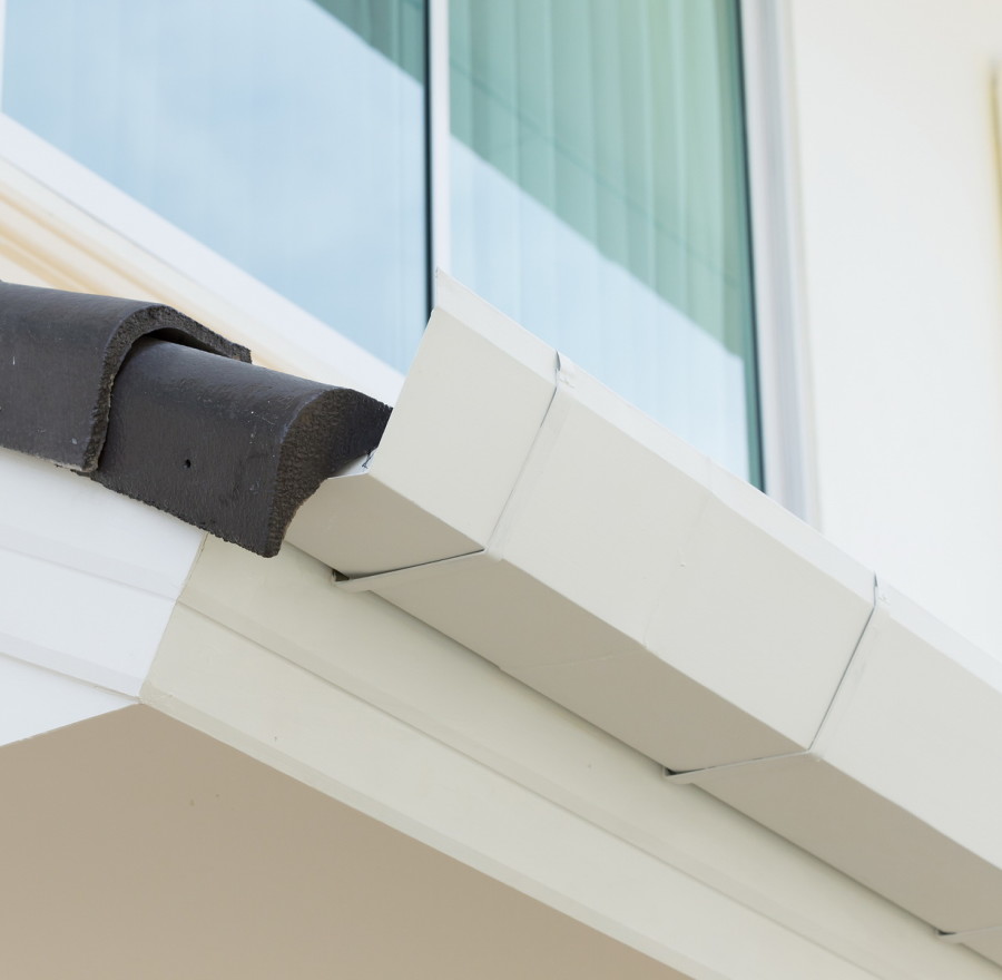 white gutter on the roof top of house